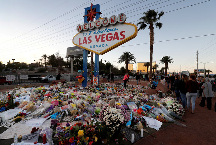 The Welcome to Las Vegas sign is surrounded by flowers and items